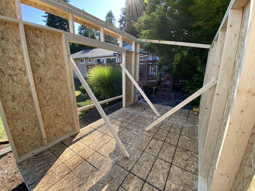 Standing up the front and back walls of the shed.