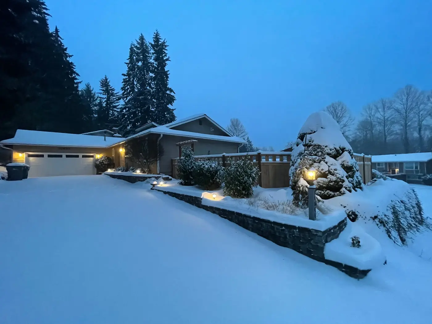 Newly fallen snow with a house as the primary subject.