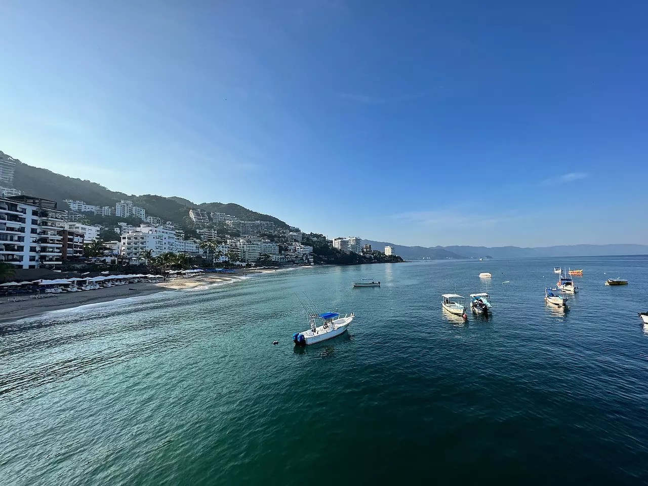 Ocean with boats looking back at the shorline in Puerto Vallarta, Jalisco