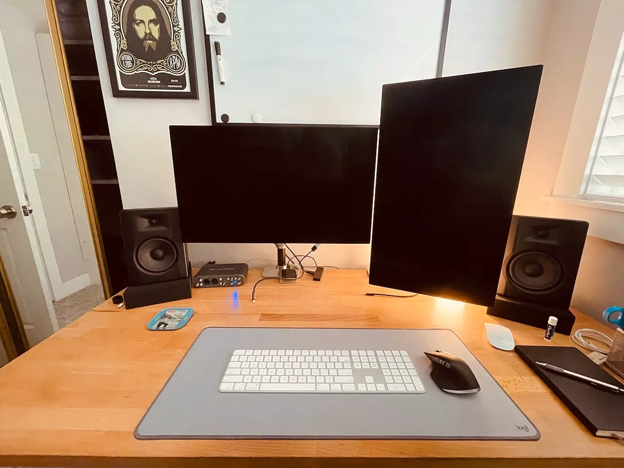 Computer desk with two monitors, speakers, mouse, and keyboard.